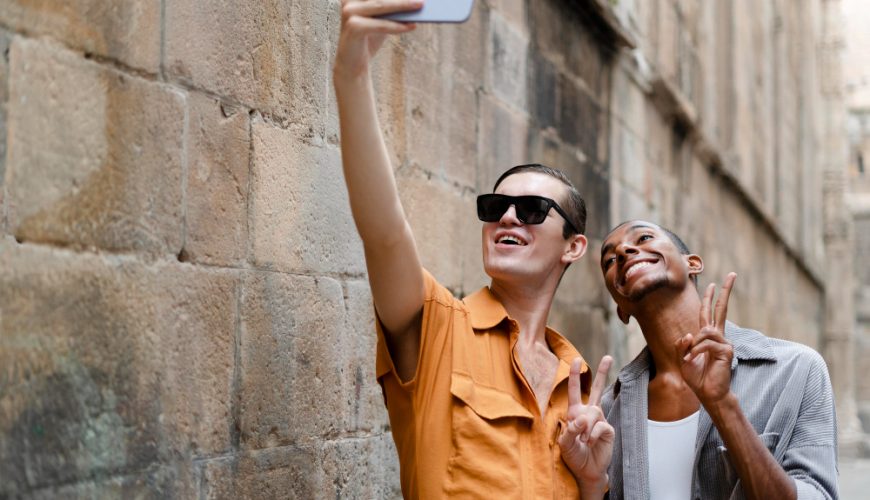 A travel influencer taking a selfie with a scenic mountain backdrop while holding a smartphone with Instagram open.